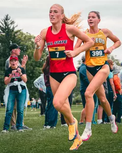 Emily Decker Passes a Toledo Runner at the Joe Piane Invitiational