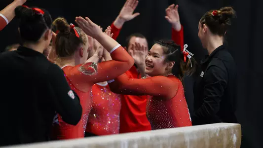 Delaney McMahon celebrates her beam routine at WMU