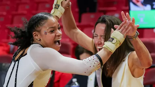 Zoe Middleton and Joanna Saleem celebrating her 9.925 on vault at the Maryland Quad