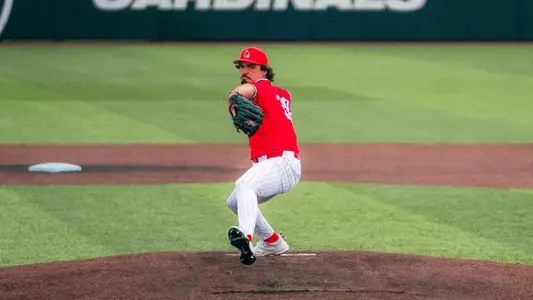 Jeremy Jones throws a pitch wearing a red jersey on March 31st against Xavier.