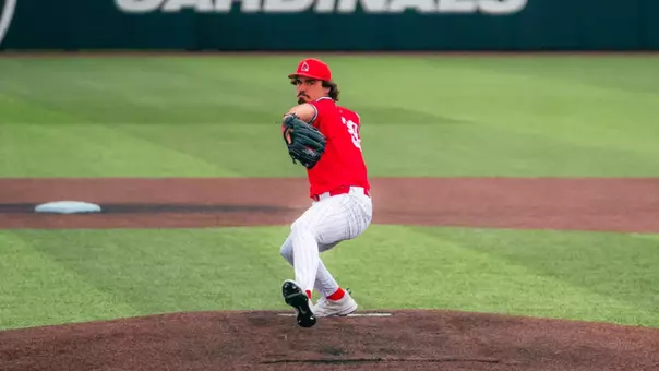 Jeremy Jones throws a pitch wearing a red jersey on March 31st against Xavier.