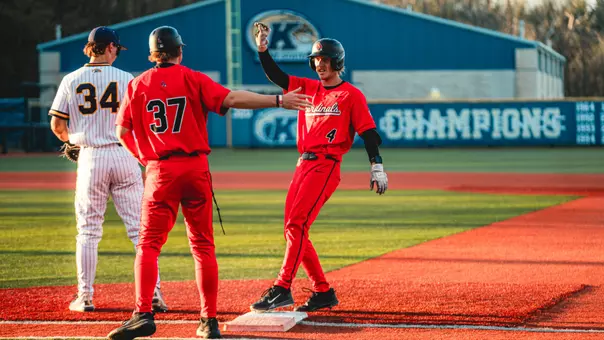 Gavin Balius giving Luke Jaksich a high five after reaching first base safely on Friday night at Schoonover Stadium in Kent, Ohio.