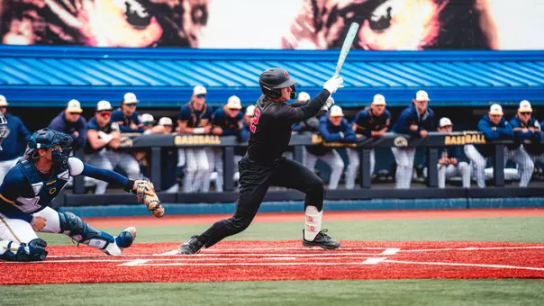 Brayden Huebner in a black Ball State baseball uniform batting on Sunday, April 19 in a game at Kent State