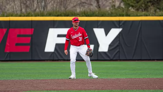 Brady Davidson in a red Ball State baseball jersey and white pants standing at second base preparing for the next pitch on defense.