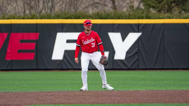 Brady Davidson in a red Ball State baseball jersey and white pants standing at second base preparing for the next pitch on defense.