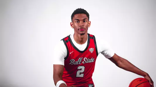 Kamden McGilverary posing in a red Ball State men's basketball jersey