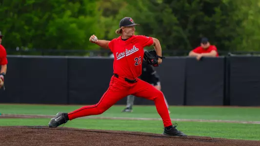 Nate Bartlett in a red uniform on the pitchers mound throwing a pitch during the Ball State baseball game on Sunday vs UMass.