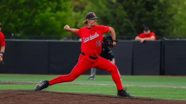 Nate Bartlett in a red uniform on the pitchers mound throwing a pitch during the Ball State baseball game on Sunday vs UMass.