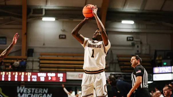 Trey Lewis in a white Western Michigan men's basketball jersey shooting a jump shot