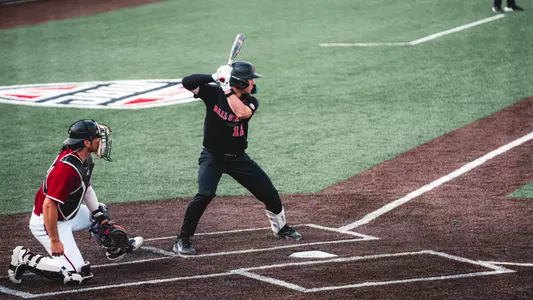 Brayden Huebner takes an at-bat against UMass on April 25th, wearing a black jersey.