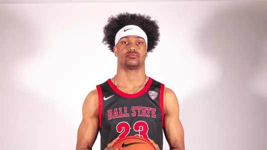Kai McGrew wearing a white headband and black Ball State basketball uniform
