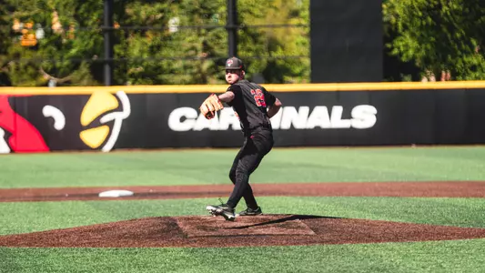 Owen Quinn in a black Ball State baseball uniform throwing a pitch