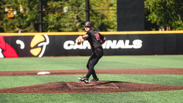 Owen Quinn in a black Ball State baseball uniform throwing a pitch