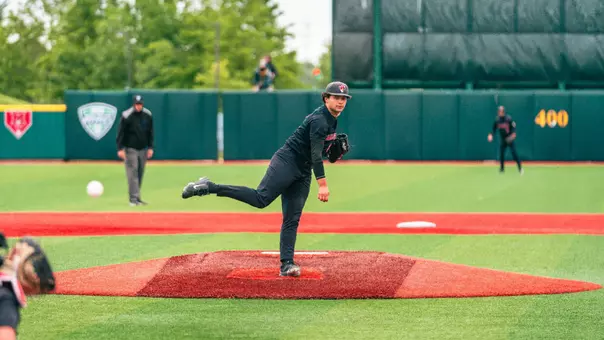 Brendan Garza in a black Ball State baseball uniform throwing a pitch on Wednesday at the MAC Tournament opener