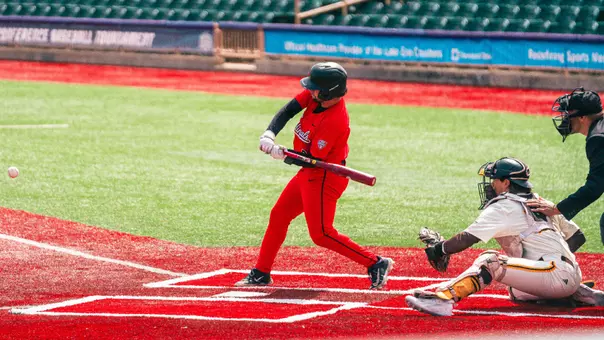 Brady Davidson in a red Ball State baseball uniform swinging a baseball bat