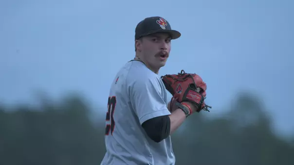 Alex Burden in a grey Ball State baseball uniform getting ready to throw a pitch