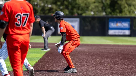 Gavin Balius in a red Ball State baseball uniform taking a lead off first base