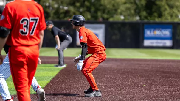 Gavin Balius in a red Ball State baseball uniform taking a lead off first base
