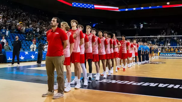 The Ball State men's volleyball team stands center court and salutes for the national anthem in the semifinals of the National Collegiate Men’s Volleyball Championship at Pauley Pavilion