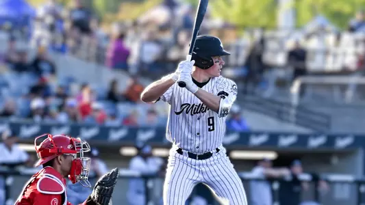 Michael Hallquist batting in a white Milwaukee Milkmen uniform