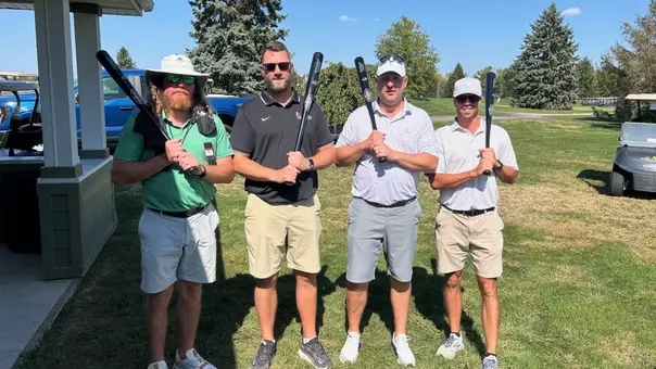 Ball State baseball alumni pose with baseball bats after playing golf at the alumni outing