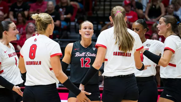 Women's volleyball team huddle around Sophie Ledbetter in the exhibition match versus UIndy on Aug. 20 in Worthen Arena