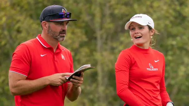 Head Coach Cameron Andry and freshman Taylor Larkins strategize before a shot at the Golfweek Red Sky Classic