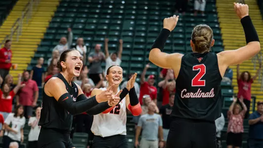 Audrey Geer, Sophie Ledbetter and Reese Axness celebrate a point in Ball State's 3-0 sweep of Dayton at the Nutter Center on Sept. 4, 2026.