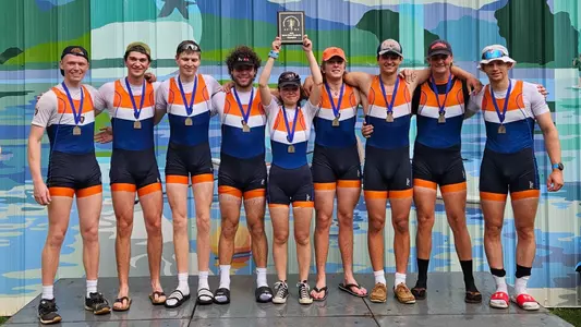 3rd Varsity 8 National Champions pictured with medals and award plaque after the race