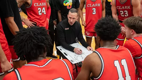 Tyler Simms in huddle at Clark University