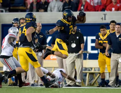 Daniel Lasco hurdles a would-be Ohio State tackler.