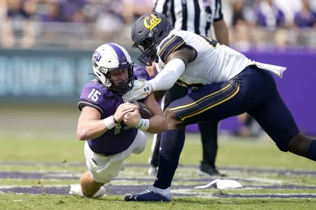 TCU quarterback Max Duggan (15) dives forward for more yardage on a carry as California linebacker Femi Oladejo, right, defends in the first half of an NCAA college football game in Fort Worth, Texas, Saturday, Sept. 11, 2021. (AP Photo/Tony Gutierrez)