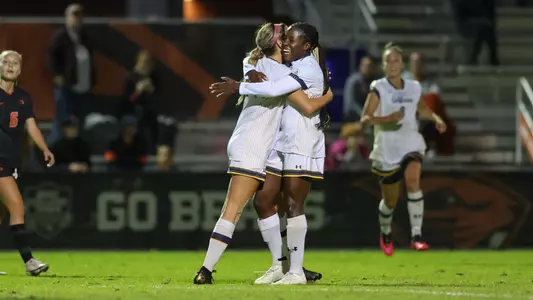 Ayo Oke and Keely Roy celebrate a goal against Oregon State.