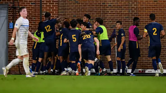 Bears celebrate with Alfredo Ortiz, who converted a PK at UNC for the eventual game-winning goal