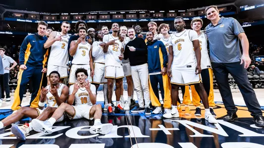 Cal men's basketball team poses at Chase Center after beating No. 18