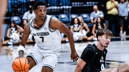 Dai Dai Ames drives past a Wright State defender on the ground at Haas Pavilion