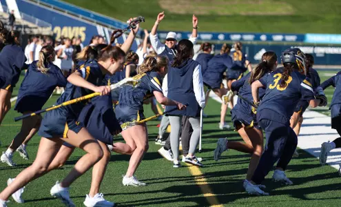 The Golden Bears rush the field to celebrate their season-opening win.