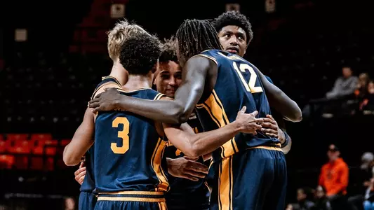 Cal players huddle up during an exhibition game at Oregon State