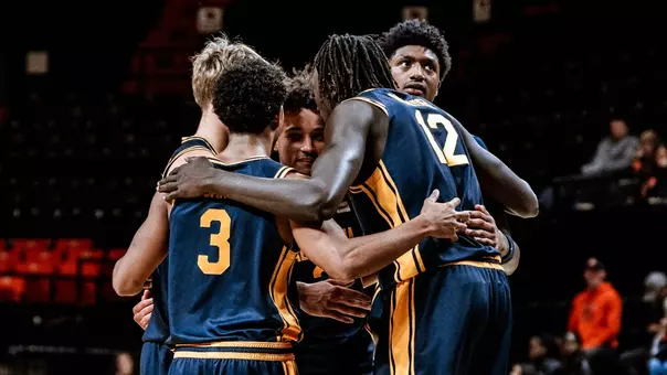 Cal players huddle up during an exhibition game at Oregon State