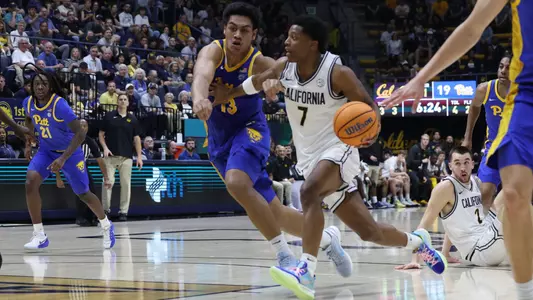 Dai Dai Ames drives on a Pitt defender at Haas Pavilion