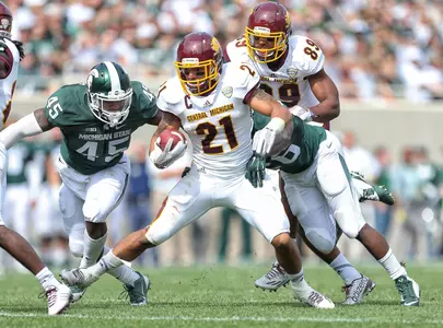 Devon Spalding (21) runs the ball against the Spartans during the 1st half.