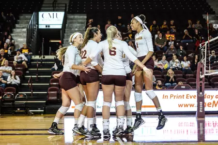 CMU volleyball players celebrate a point Sunday in their five-set victory over Western Michigan at McGuirk Arena.