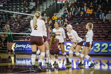 CMU players celebrate a point in Thursday's victory over Eastern Michigan at McGuirk Arena.