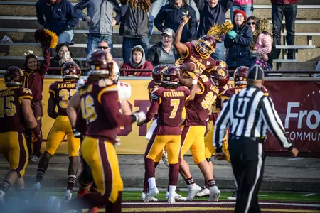 CMU's Josh Cox celebrates with teammates his fourth-quarter pick-six Saturday in CMU's 24-21 victory on homecoming over Ball State.