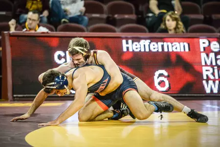 Central Michigan junior Colin Heffernan battles Virginia's Andrew Atkinson in the 157-pound match Sunday at McGuirk Arena.