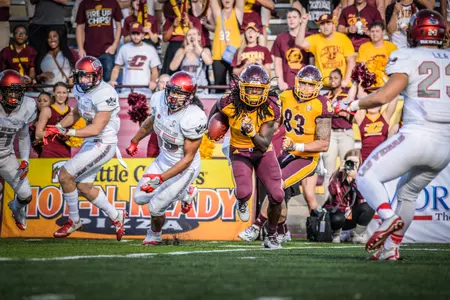 CMU junior wideout Corey Willis celebrates a touchdown catch with teammate Devon Spalding.