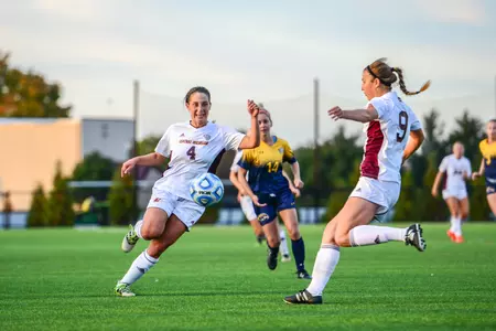 CMU's Christie Chiesa (left) is presented the Enberg Scholar-Athlete of the Year Award by the CMU legend himself last week during a CMU football game at Kelly/Shorts Stadium.