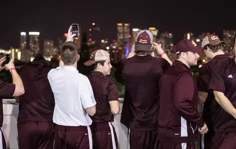 CMU players take photos of the Miami skyline Thursday night during the Miami Beach Bowl welcome dinner at Marlins Park.