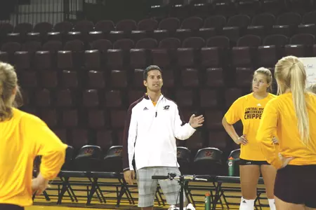 CMU coach Mike Gawlik (left) addresses his players during a Friday practice.