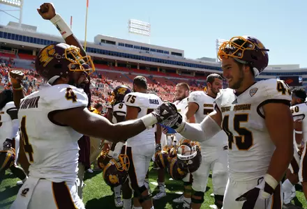 CMU's Winslow Chapman (left) and Joe Ostman celebrate Saturday's win at Oklahoma State's Boone Pickens Stadium.